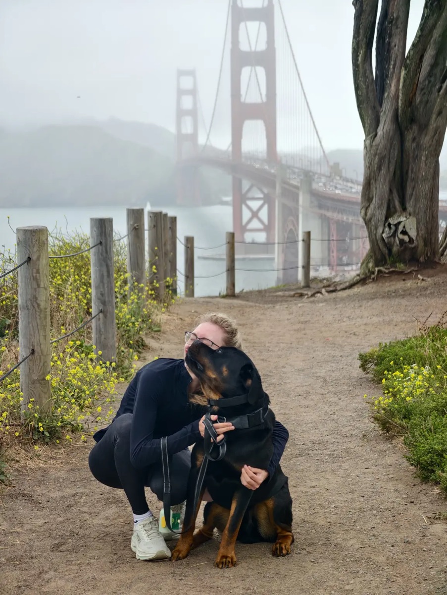 Sandra hugging Mars with the Golden Gate Bridge in the background